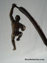Load image into Gallery viewer, The Unwritten future... a man hangs on with one arm while his body swings on the tip of a cattail.  bronze sculpture that contemplates choices

