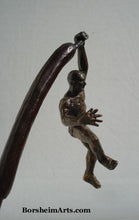 Load image into Gallery viewer, Bob Fosse hand with extended fingers gives the impression that the bronze figure hanging from one arm is a little nervous.  What does his future hold?  art about choices