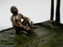 Load image into Gallery viewer, Detail of man sitting and leaning back to look up to the other man.  This image shows the lovely green patina with rings for subtle texture on the giant (to him) lily pad bronze sculpture