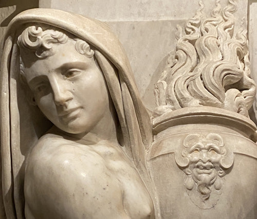 a sculpture by Pierino da Vinci of a male figure that was made in the time and style of Michelangelo holding urn with marble fire rising above it. Pescia Duomo in Tuscany