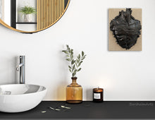 Cargar imagen en el visor de la galería, Bathroom interior with a sink, mirror, and decorative elements, including wall art in bronze.
