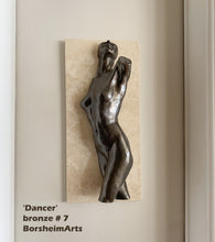 Load image into Gallery viewer, A bronze sculpture of a dancing nude female figure torso mounted on a rectangular beige stone tile, shown against an off-white wall. Text in the lower left reads “Dancer bronze # 7 BorsheimArts.
