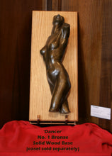 Load image into Gallery viewer, Bronze sculpture of the torso of a dancing female figure mounted on a vertical light wood plaque, displayed against a dark wood background with a red cloth at the bottom and a small label card.
