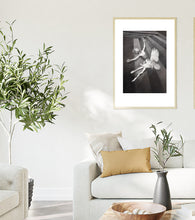 Charger l'image dans la galerie, Living room with a framed black and white original drawing on the wall, a white sofa with a yellow ochre pillow, and decorative olive plants.
