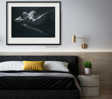 Load image into Gallery viewer, Fine art print of a black and white drawing of a nude woman reclinging in bed and daydreaming to the ceiling..  hung on the wall over the bed, this artwork is well suited for the bedroom wall art.
