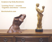 Laden Sie das Bild in den Galerie-Viewer, Ceramic female leaning torso sculpture rests on a wooden dresser next to a bronze sculpture of a couple embracing, titled Together and Alone.  Both by artist Kelly Borsheim
