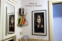 Load image into Gallery viewer, Framed artwork titled &#39;Library of Dreams&#39; on a wall with books on a shelf.
