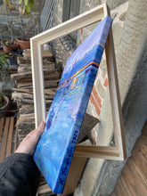 Laden Sie das Bild in den Galerie-Viewer, Framed painting held by a person showing artist's signature and date on canvas side  with a rustic background
