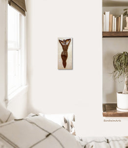 Lots of white wall space surrounds the beautiful female nude bronze figure, hung on the wall in this Boho bedroom.