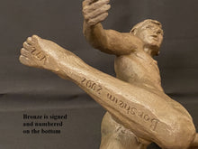 Load image into Gallery viewer, A close-up of a bronze sculpture depicting a male athlete in mid-motion, with one leg extended upward. The sculpture is signed and numbered on the bottom by the artist Kelly Borsheim, as noted by the text overlay.
