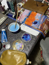 Laden Sie das Bild in den Galerie-Viewer, Artistic workspace with painting supplies including a paintbrush, paint tube, and palette on a table.
