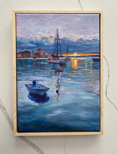 Laden Sie das Bild in den Galerie-Viewer, Framed painting of a harbor scene with boats and buildings at sunset.
