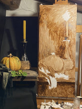 Laden Sie das Bild in den Galerie-Viewer, Still life painting setup in art studio.  Live models include an orange mottled pumpkin and green acorns with oak leaves.  There is also an antique Italian candlestick holding a beeswax taper candle.  
Next to the models are the tall, vertical canvas with a monochromatic underpainting started.
