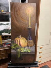 Laden Sie das Bild in den Galerie-Viewer, Painting of a candle, pumpkin, and other objects on an easel in a room.
