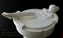Carica l'immagine nel visualizzatore di Gallery, Marble sculpture of a woman lying in a small pool with legs extended out by Vasily Fedorouk against a black background.
