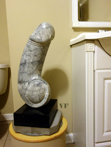 Contemporary art: Grey with black stone veins marble sculpture resembling a phallic shape in a bathroom setting