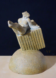Ceramic sculpture of a reclining male figure on a cube embedded in a half-sphere against a dark background