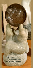 將圖片載入圖庫檢視器 Stone sculpture of a couple of human figures holding a large round crystal above their heads, displayed indoors

