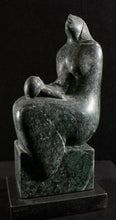 Carica l&#39;immagine nel visualizzatore di Gallery, Dark green marble sculpture of a seated mother figure with squirming child on her lap as she looks to the sky.  sculpture on a black background
