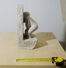 Laden Sie das Bild in den Galerie-Viewer, Stone sculpture of a male figure on a beige surface with a tape measure for scale.
