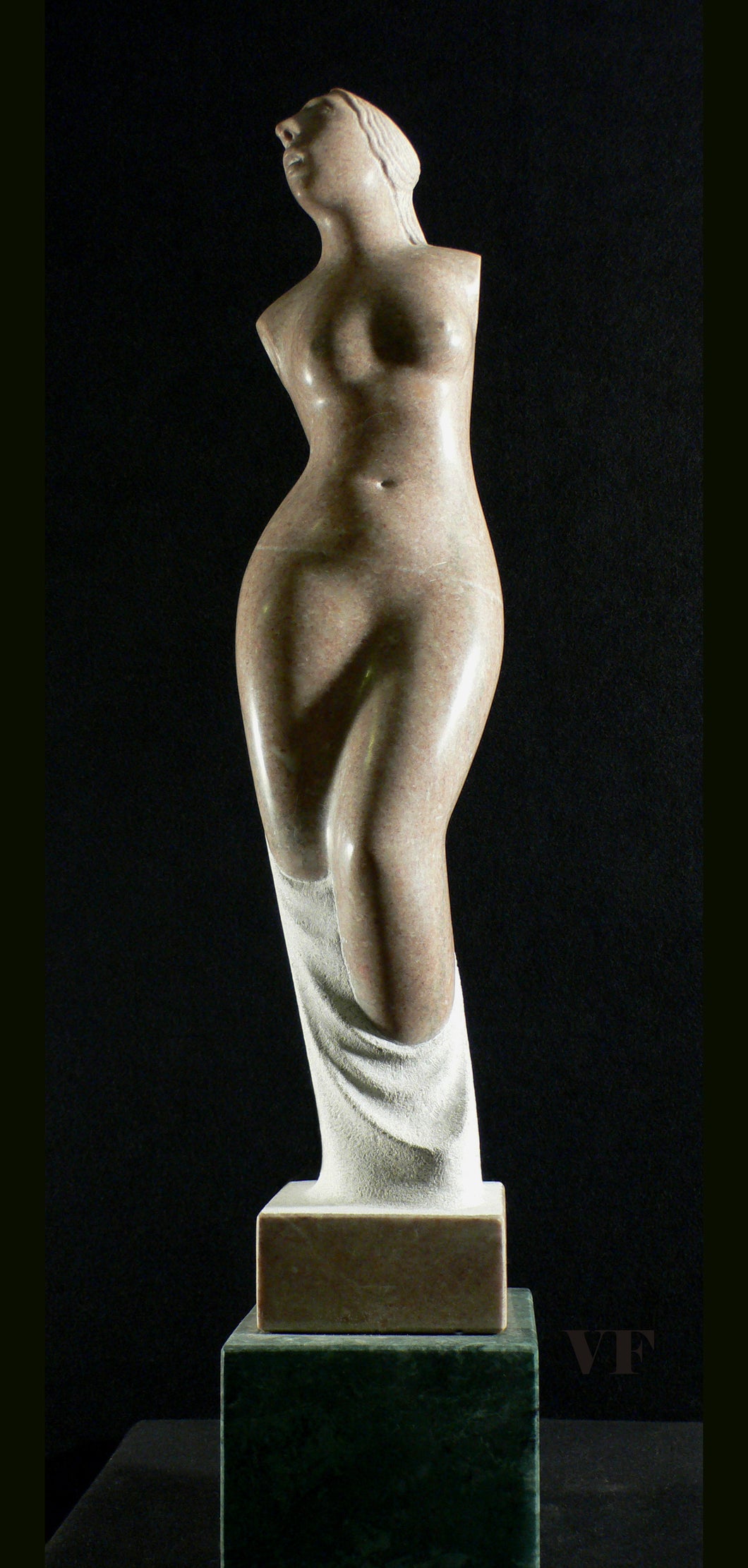 Statue of a nude female figure of Greek goddess Venus on a dark background