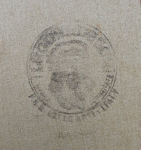 Circular emblem or logo stamped onto an Italian textured linen canvas, the backside