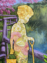 Laden Sie das Bild in den Galerie-Viewer, Artistic silhouette of a person (a young boy, standing and looking down) holding a garden fork with floral patterns inside his body, set against a garden background.
