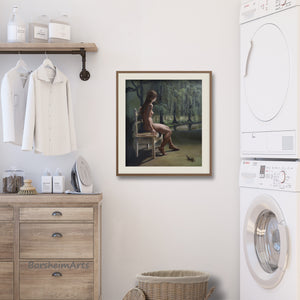 Laundry room with framed artwork, washing machine, dryer, and wooden cabinet.