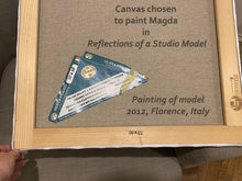 Load image into Gallery viewer, Back side of Italian Canvas showing size and brand on the stretcher bars, with details of the 50 x 60 cm canvas on a triangle piece of paper sold with the canvas. 
