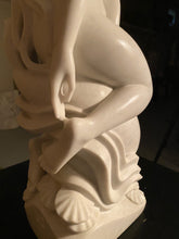 將圖片載入圖庫檢視器 White marble sculpture of a seated figure with a shell on a dark surface.  Showing the negative / air spaces carved into the stone statue.
