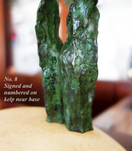 Laden Sie das Bild in den Galerie-Viewer, A close-up of a green textured bronze sculpture kelp detail standing on a beige limestone base, with overlaid text reading 'No. 8 Signed and numbered on kelp near base.'
