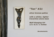 Laden Sie das Bild in den Galerie-Viewer, Ten #21 that has a rare silvery bronze patina. She is paired with a whiter, lighter travertine stone than the typical creamier color. Enjoy this detail image of the woman&#39;s back bas-relief sculpture by Kelly Borsheim
