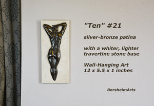 Ten #21 that has a rare silvery bronze patina. She is paired with a whiter, lighter travertine stone than the typical creamier color. Enjoy this detail image of the woman's back bas-relief sculpture by Kelly Borsheim