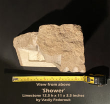 Cargar imagen en el visor de la galería, Bird's eye view of a limestone figure sculpture with a measuring tape showing the dimensions on a black background.
