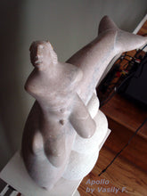 Load image into Gallery viewer, Top view of the sculpture of the naked God Apollo looking skywards as he rides a dolphin.  Stone carving by Vasily Fedorouk
