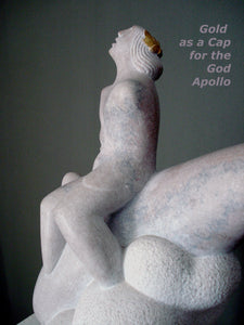 Profile view of the god Apollo.  You may see the addition of gold in the shape of a cap over the repeating curving lines of the man's hair.