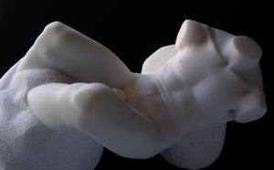 White marble sculpture of the nude torso of a man.  his legs are embedded in stone and arms cut off as the Greek method  Nude art by Vasily Fedorouk