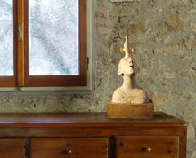 Carica l'immagine nel visualizzatore di Gallery, Ceramic sculpture on a wooden dresser against a stone wall with a window.
