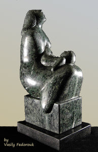 Green marble tabletop sculpture of a mother with a squirming child on her lap looks upwards to God, art by Vasily Fedorouk