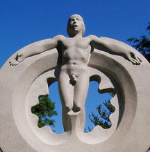 Cargar imagen en el visor de la galería, Detail of stone carving of standing man&#39;s naked body.  His arms are extended beside him, lying on a large circular shape.  Spaceman is a limestone carving sculpture by Vasily Fedorouk
