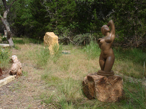 Gemini Bronze Garden Sculpture Voluptuous Abstract Figure Statue with Two Faces is shown here at a sculpture garden exhibition in Dripping Springs, Texas