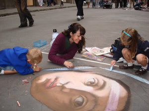 Street artist Kelly Borsheim often invites children to draw with her in Florence Italy.