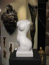Charger l&#39;image dans la galerie, The art booth exhibit of bronze nudes of men or women, as well as this white marble nude torso of a woman.  Art by Kelly Borsheim
