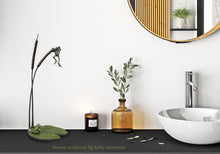 Load image into Gallery viewer, Bronze sculpture of cattails and two frogs (one hanging from the top of the cattail while the other sits on a lily pad and watches the hanging frog, looks great in a bathroom setting
