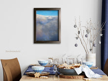 Cargar imagen en el visor de la galería, This cloud painting print in a medium size is in subtle blues and oranges and compliments well this cozy dining room with blue accents.  art by Kelly Borsheim
