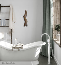 Load image into Gallery viewer, Dancer wall-mounted bronze torso of a woman hangs in an elegant bathroom with an equally curvaceous tub.
