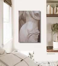Load image into Gallery viewer, Shown here in a boho bedroom, is the monochromatic painting titled &quot;Fontana di Lucca&quot; features a close-up view of a stone sculpture of a female torso at a public water fountain in Tuscany.
