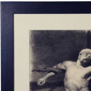 Frame detail of black wood with subtle wood grain wraps around an off-white mat, and glass finishes the protection of this fine art male nude charcoal drawing after Fortuny