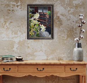 country living is enhanced with warm colors and this original painting of jasmine florals.  shown here above a side table and a vase of cottom blooms.