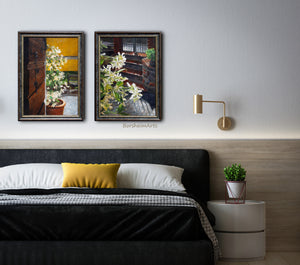 The muted golden pillow on this dark grey bed really compliments the color in this pair of paintings about jasmine flowers. 